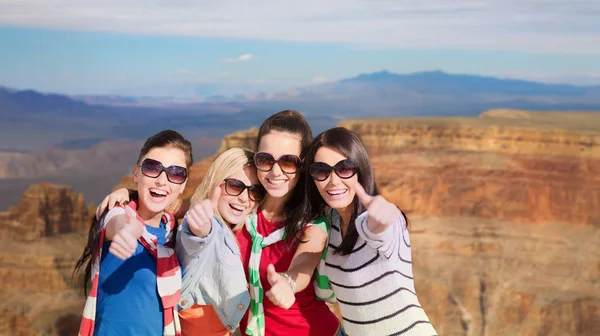 Teenage girls or young women showing thumbs up — Stock Photo, Image