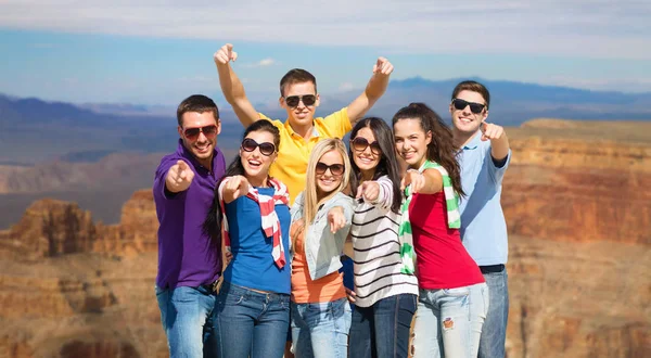 Happy friends pointing at you over grand canyon — Stock Photo, Image