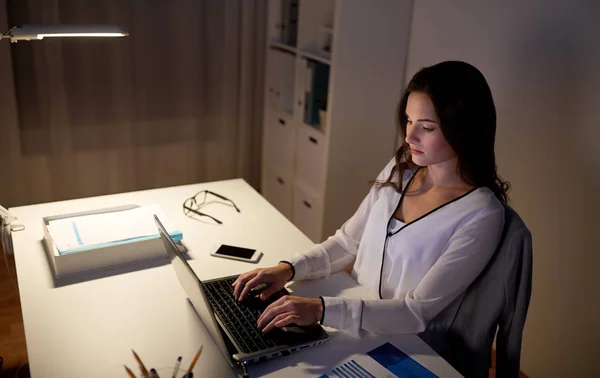 Businesswoman with laptop at night office — Stock Photo, Image