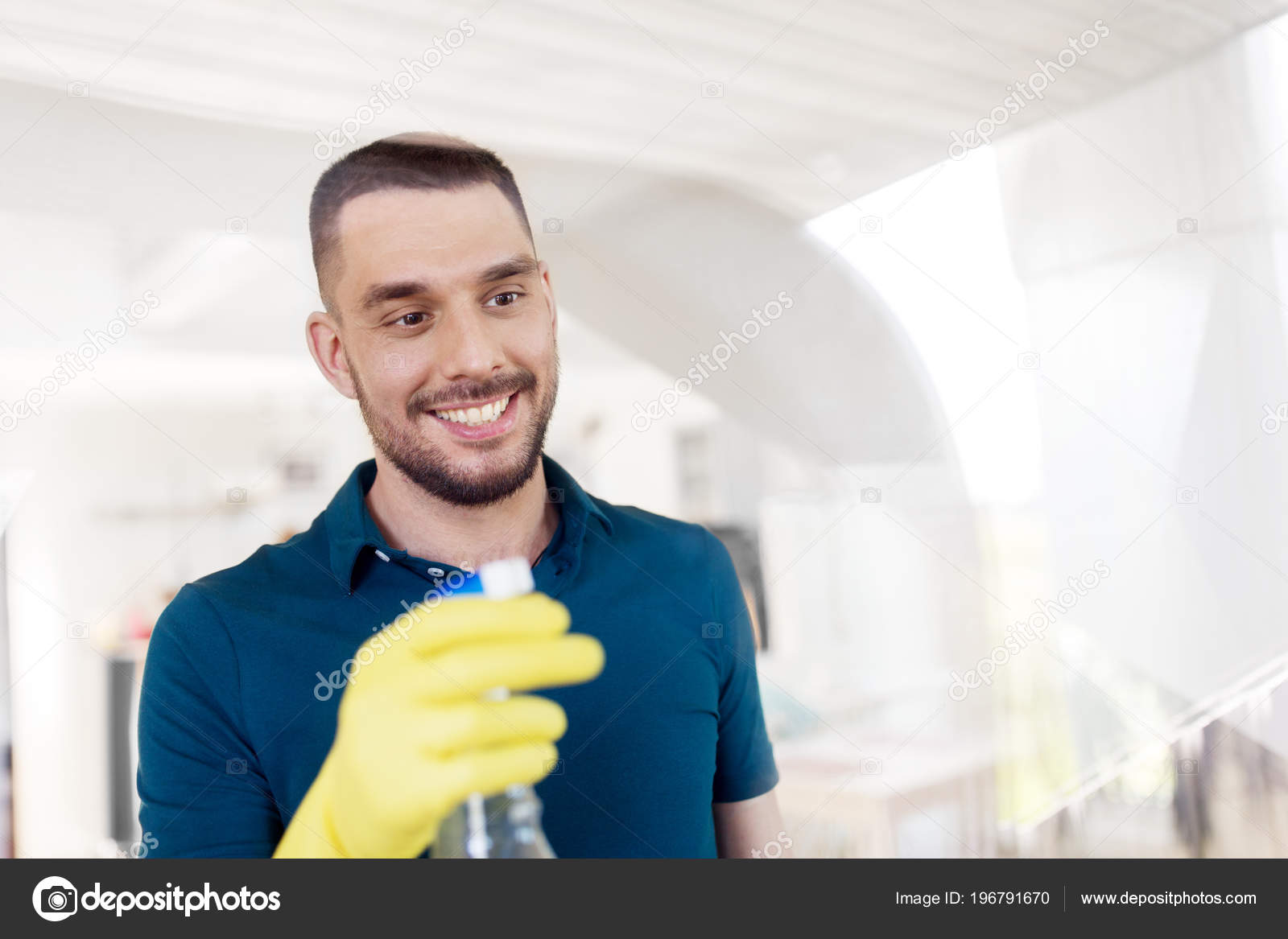 Man in rubber gloves cleaning window with spray Stock Photo by ©Syda_Productions 196791670