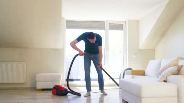 Man with vacuum cleaner at home — Stock Video