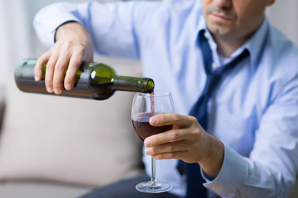 Alcoholic pouring red wine to glass at home — Stock Photo, Image