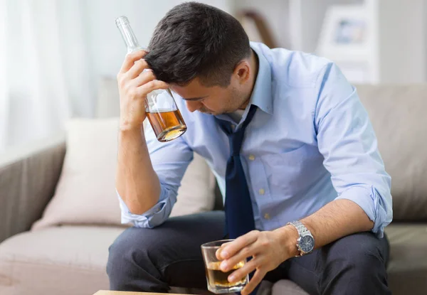 Alcoholic with bottle drinking whiskey at home — Stock Photo, Image