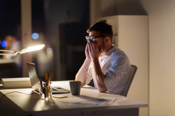 Trött affärsman med laptop i natt office — Stockfoto