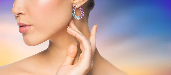 Close up of beautiful woman face with earring — Stock Photo, Image