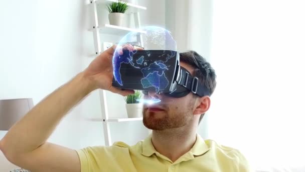 Man in vr headset with earth projection at home — Stock Video