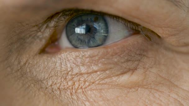 Close up of blinking senior woman eye — Stock Video