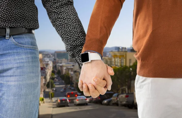 Close up of male gay couple hands with smartwatch — Stock Photo, Image