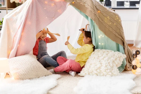 Ragazze con stoviglie che giocano in tenda a casa — Foto Stock