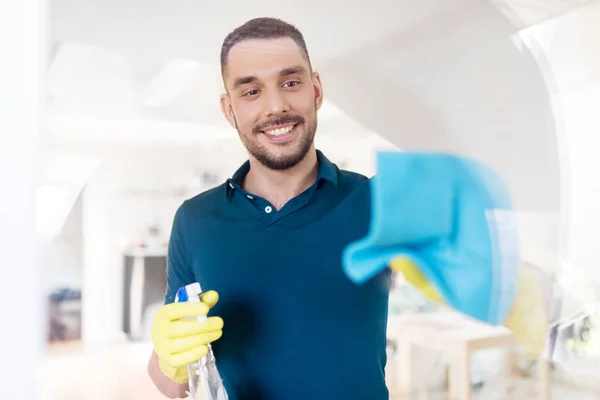 Man in rubberen handschoenen venster met doek schoonmaken — Stockfoto