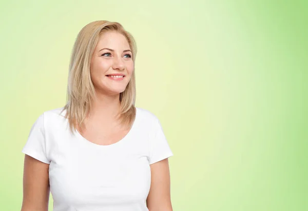 Happy woman in white t-shirt over lime green — Stock Photo, Image