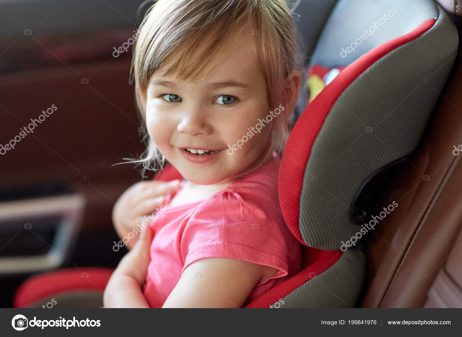 Close Up Of Little Girl Sitting In Baby Car Seat Stock