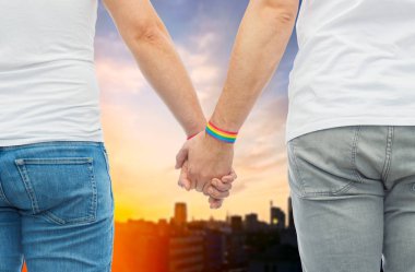 male couple with gay pride rainbow wristbands clipart