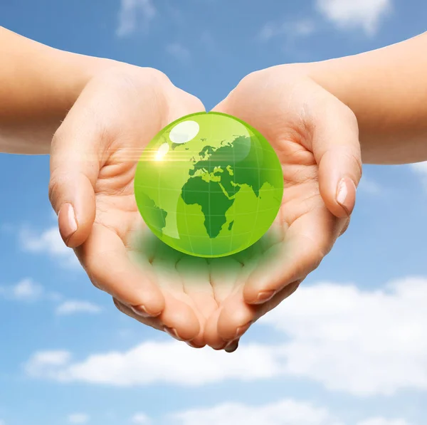 Close up of female hands holding green globe — Stock Photo, Image