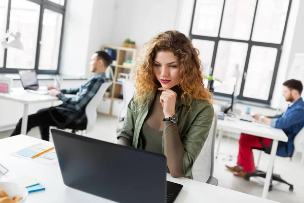 Mulher criativa com laptop trabalhando no escritório — Fotografia de Stock