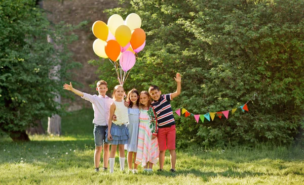 Niños felices con globos en la fiesta de cumpleaños de verano —  Fotos de Stock