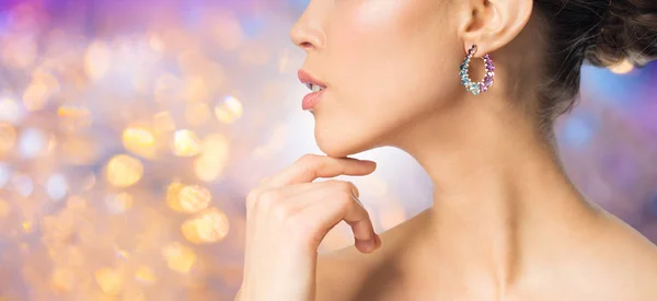 Close up of beautiful woman face with earring — Stock Photo, Image