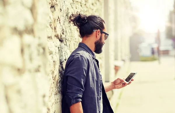 Primer plano del hombre con teléfono inteligente en la pared de piedra —  Fotos de Stock