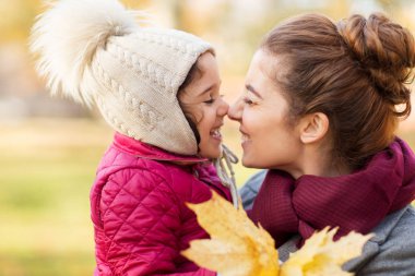 mother and little daughter with autumn leaves clipart