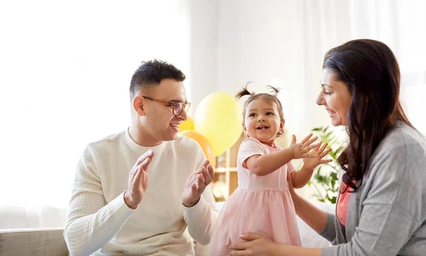 Happy baby girl and parents at home birthday party — Stock Photo, Image