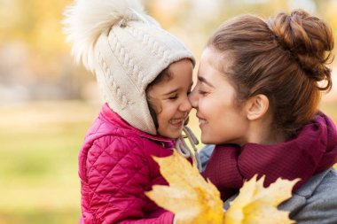 mother and little daughter with autumn leaves clipart