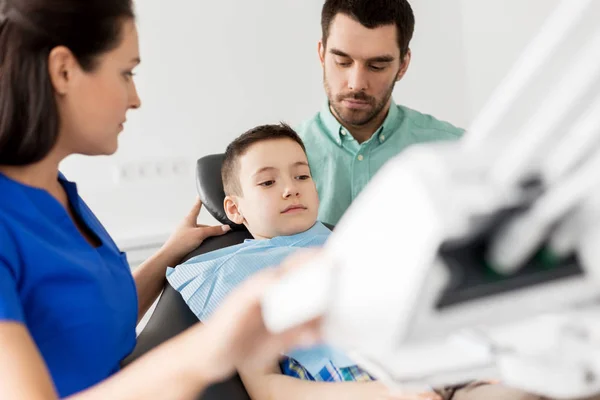 Pai e filho visitando dentista na clínica odontológica — Fotografia de Stock