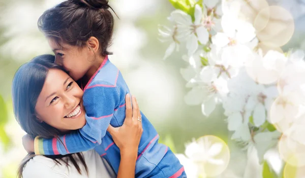 Happy mother and daughter hugging and kissing — Stock Photo, Image