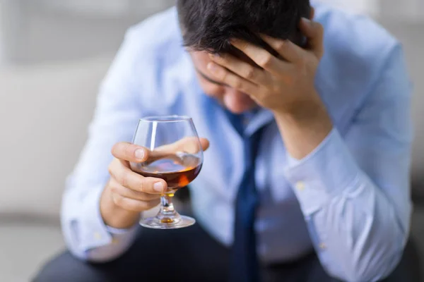 Drunk man with glass of alcohol at home — Stock Photo, Image