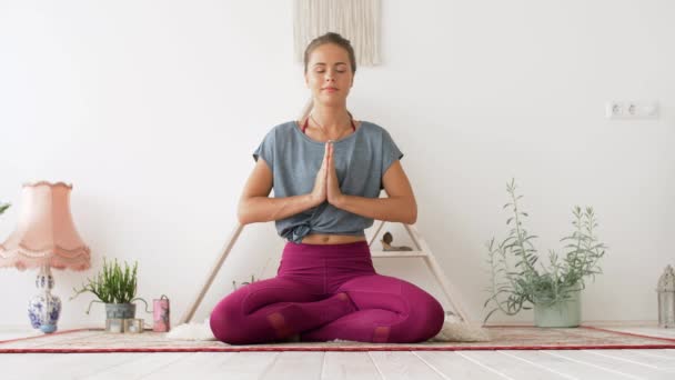 Nilüfer çiçeğiyle meditasyon yapan kadın yoga stüdyosunda poz veriyor. — Stok video