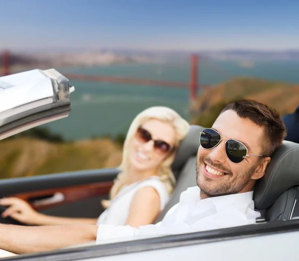 Happy couple driving in convertible car — Stock Photo, Image