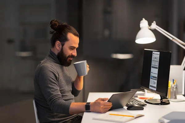 Creative man with computer working at night office — Stock Photo, Image