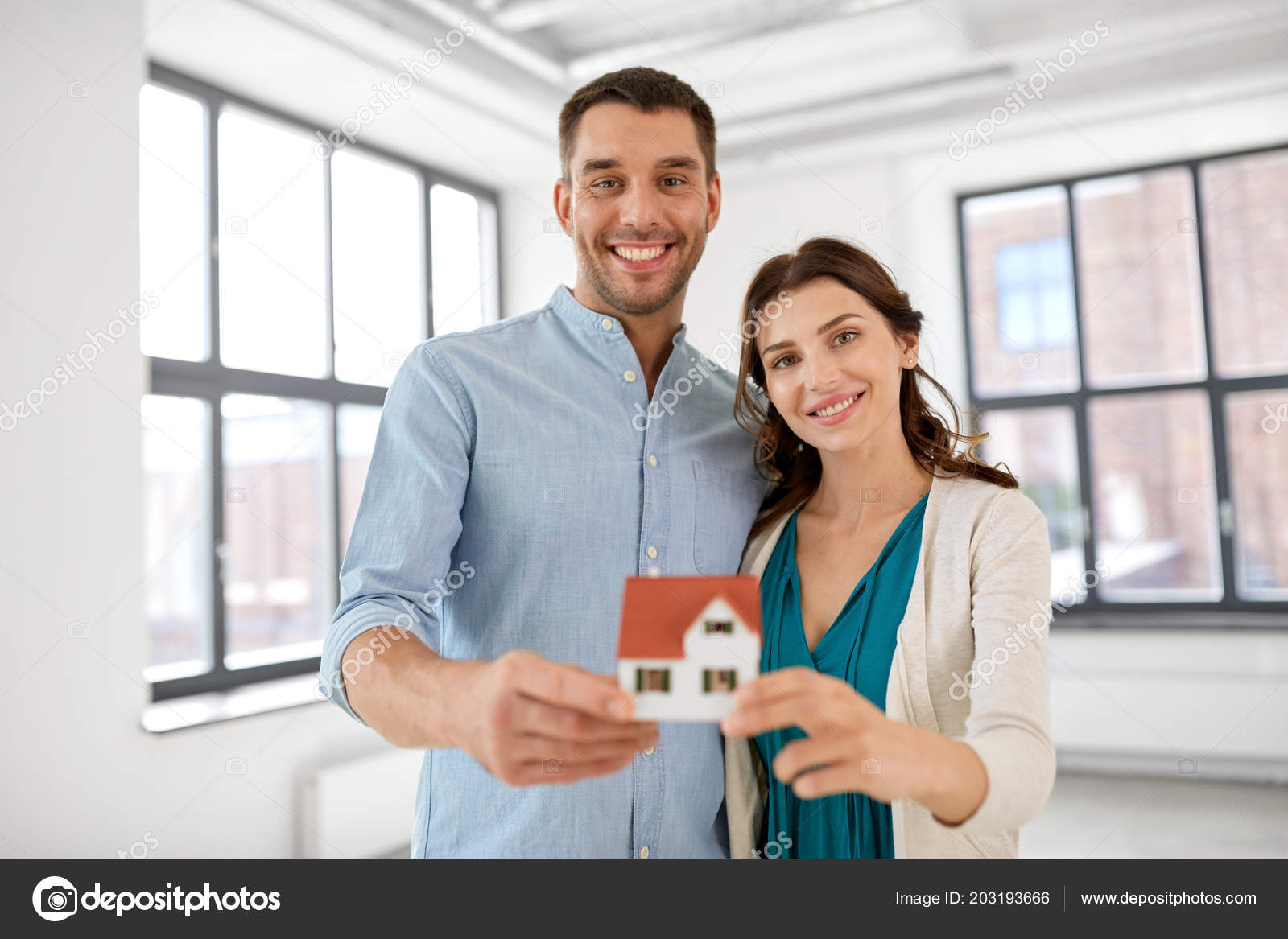 Happy couple with house model at new home Stock Photo by ©Syda_Productions  203193666