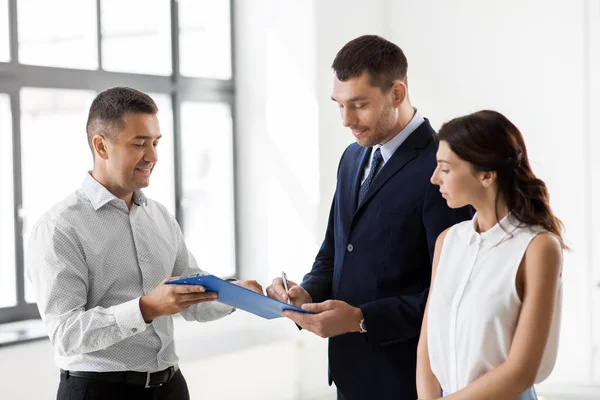 Realtor showing contract document to customers Stock Image