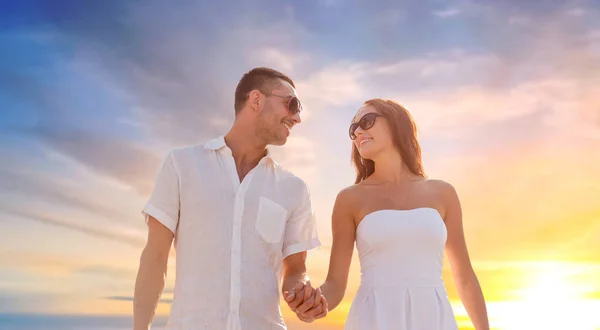 Feliz pareja cogida de la mano sobre la puesta del sol cielo —  Fotos de Stock