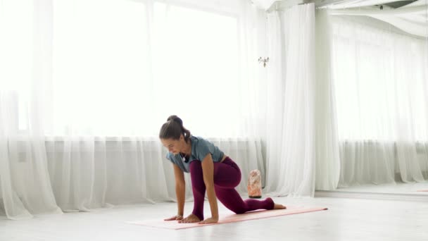 Mujer haciendo ejercicio de alta embestida en estudio de yoga — Vídeos de Stock