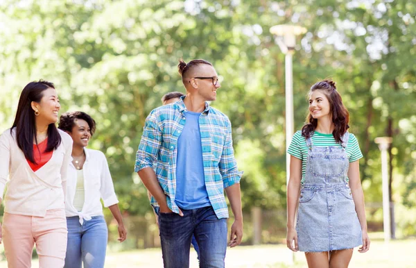Group of happy international friends in park — Stock Photo, Image