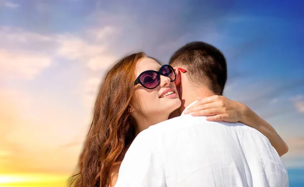 Feliz pareja abrazándose sobre la puesta del sol cielo fondo —  Fotos de Stock