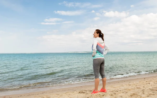 woman in sports clothes on beach