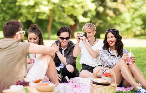 Přátelé s fotoaparátem fotografovat na letní piknik — Stock fotografie