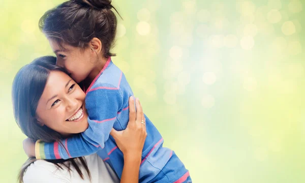 Happy mother and daughter hugging and kissing — Stock Photo, Image