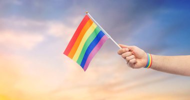 hand with gay pride rainbow flag and wristband clipart