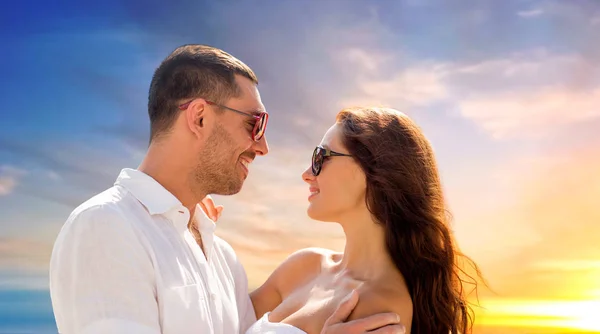 Feliz casal sorrindo em óculos de sol abraçando — Fotografia de Stock