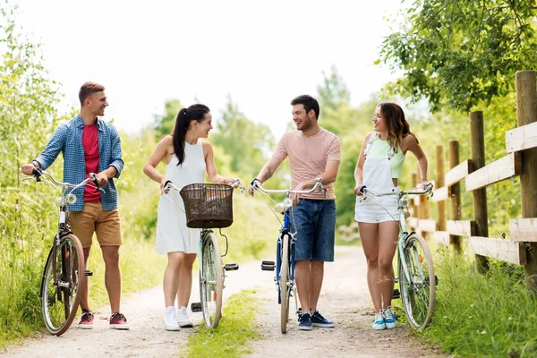 Amici felici con biciclette a scatto fisso in estate — Foto Stock