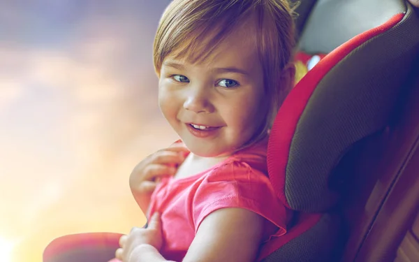 Close up of little girl sitting in baby car seat — Stock Photo, Image