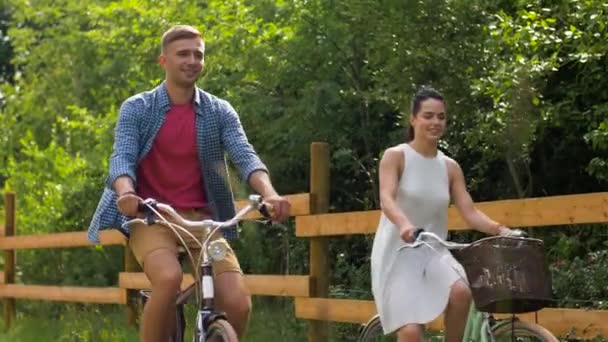 Happy couple riding fixed gear bicycles in summer — Stock Video