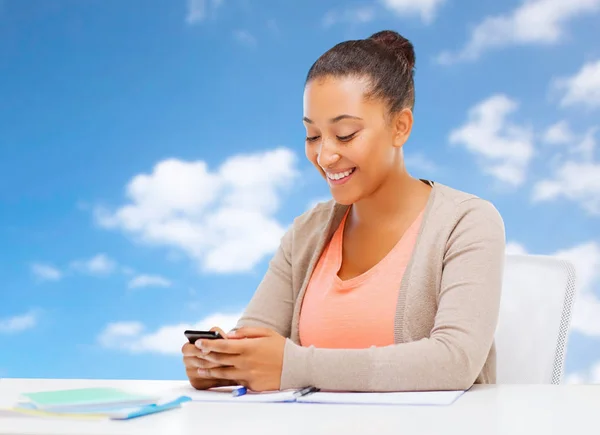 African student girl with smartphone and notebooks — Stock Photo, Image