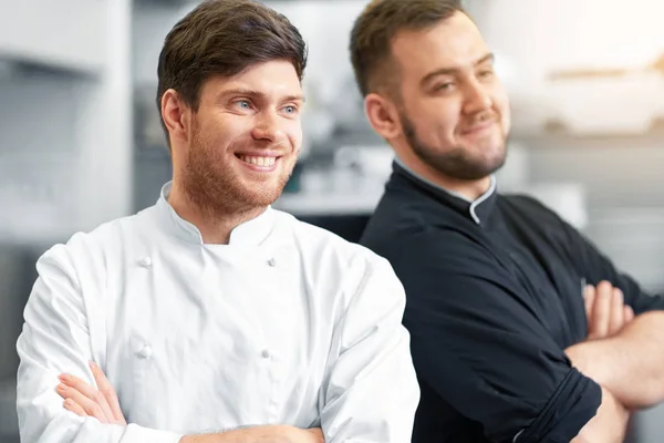 Щасливий усміхнений шеф-кухар і готувати на кухні ресторану — стокове фото