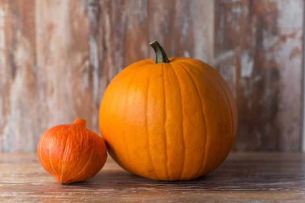 Pumpkin and red kuri squash on wooden background — Stock Photo, Image