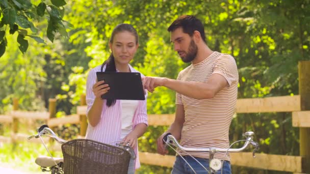 Ζευγάρι με ποδήλατα στο πάρκο καλοκαίρι και pc ταμπλετών — Αρχείο Βίντεο