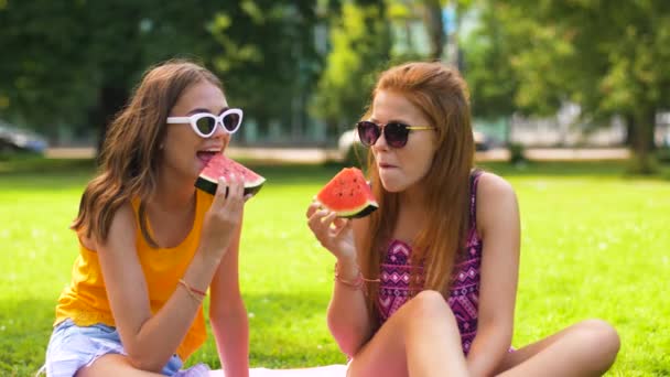 Dospívající dívky jíst meloun na piknik v parku — Stock video